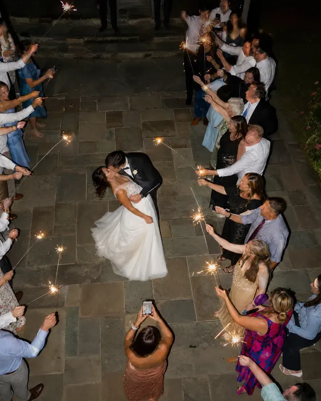 The couple dancing as guests line the path with sparklers, seen from above